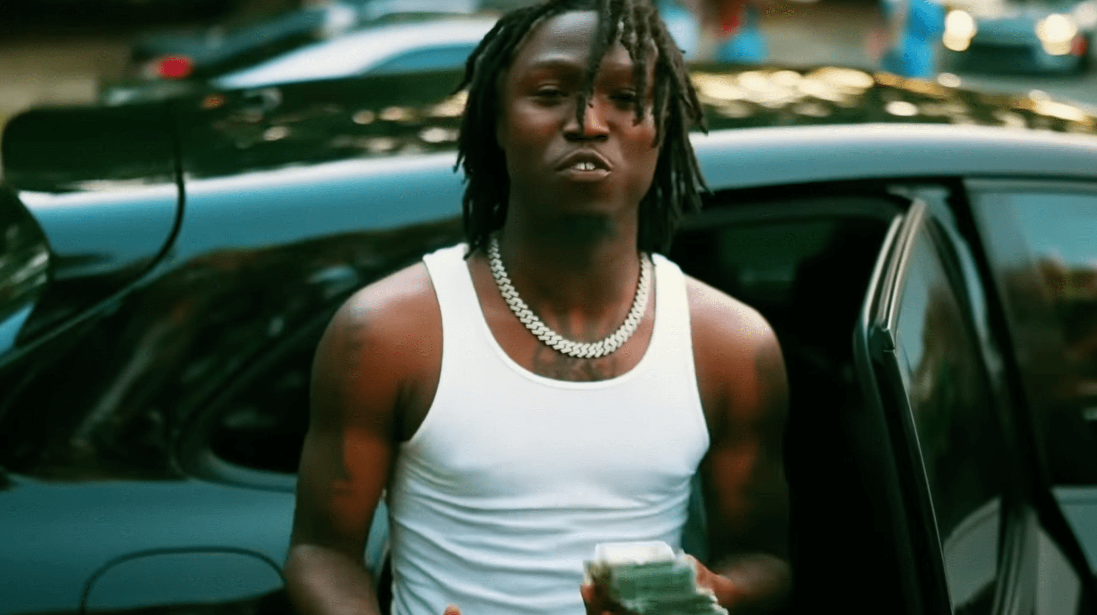 Lul Timm standing outdoors in a white tank top