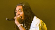 Wiz Khalifa performing onstage, the rapper who reacted to Drake and Pinkchyu’s viral barking moment.