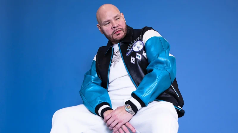 Fat Joe seated against a blue backdrop in a 2025 Complex portrait