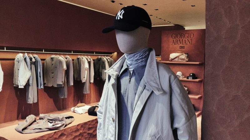 A black Yankees cap and layered light jacket from Giorgio Armani & Kith on a mannequin at the Omotesando pop-in