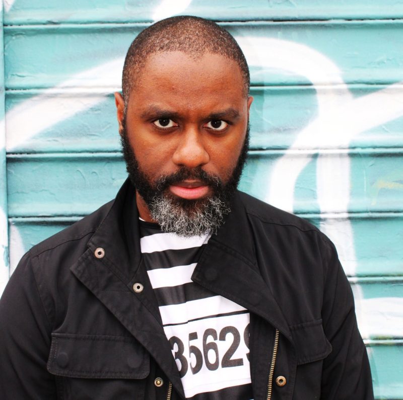 Kevin Anglade standing in front of a painted wall